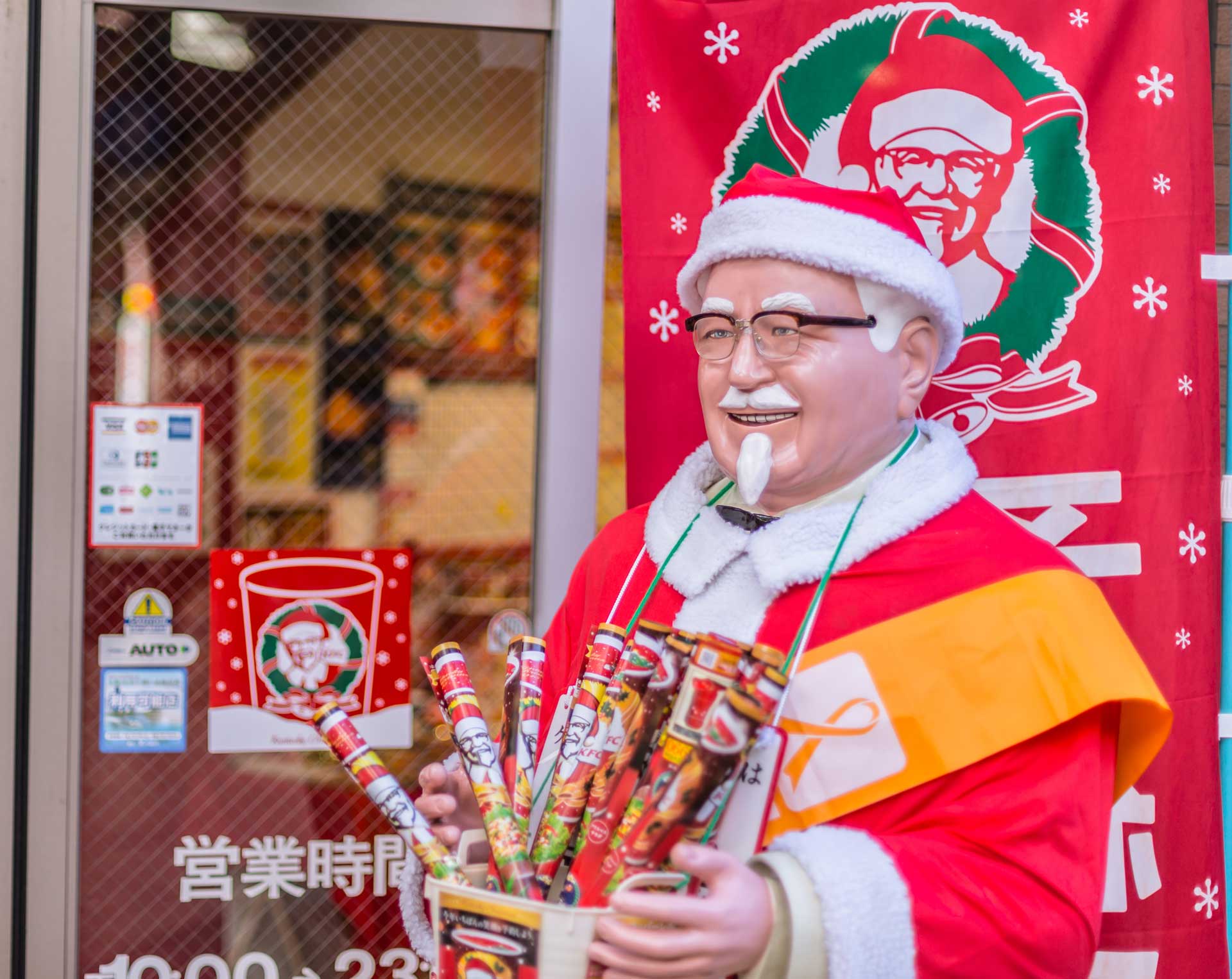 Japanese KFC at Christmas, with a Colonel Sanders statue dressed like Santa