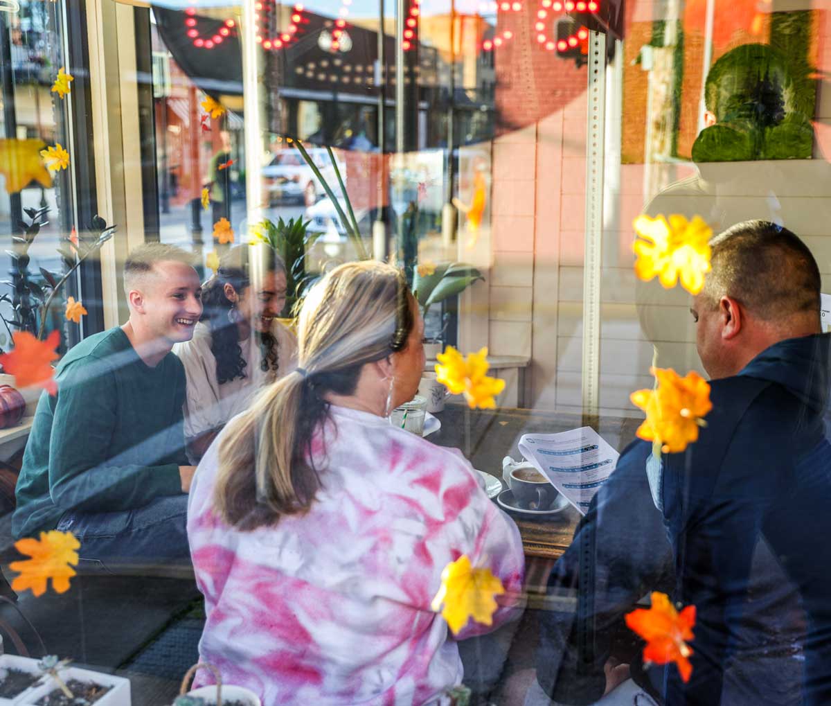 Family eating at a diner, seen through the window